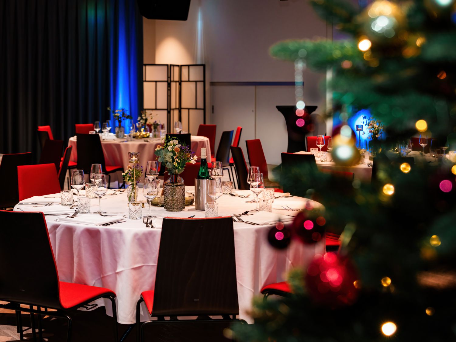 Foto hinter Weihnachtsbaum geschossen mit Blick auf gedeckten Galatisch